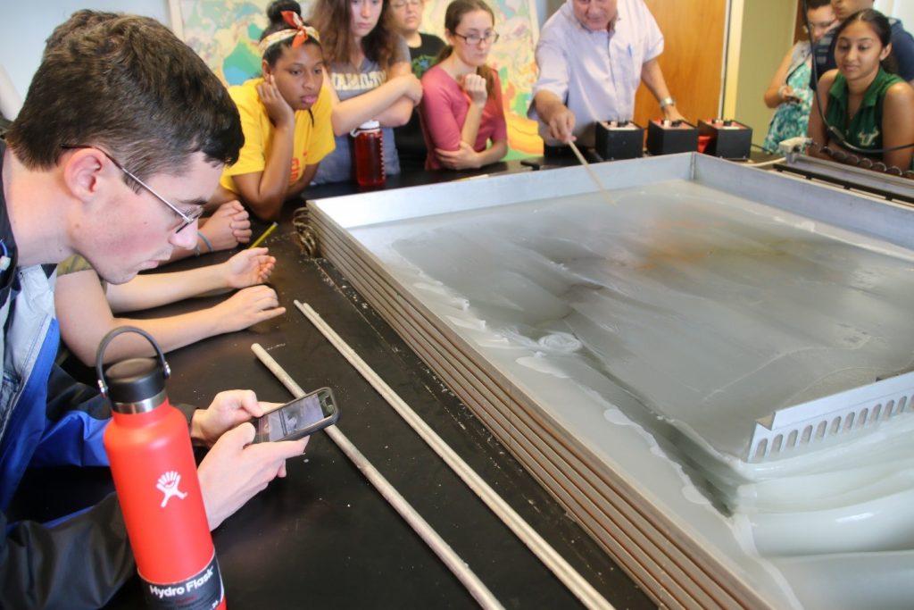 REU students observe (and snap photos of) a microplate that formed on the left edge of the wax crust. Dr. David Naar points out how the microplate is fixing itself to the side of a larger ‘plate’
