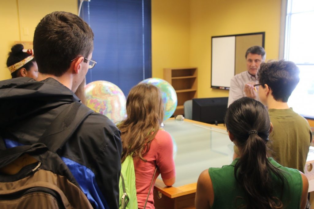 Students from the Research Experience for Undergraduates program listen to USFCMS faculty member Dr. David Naar explain the theory of plate tectonics