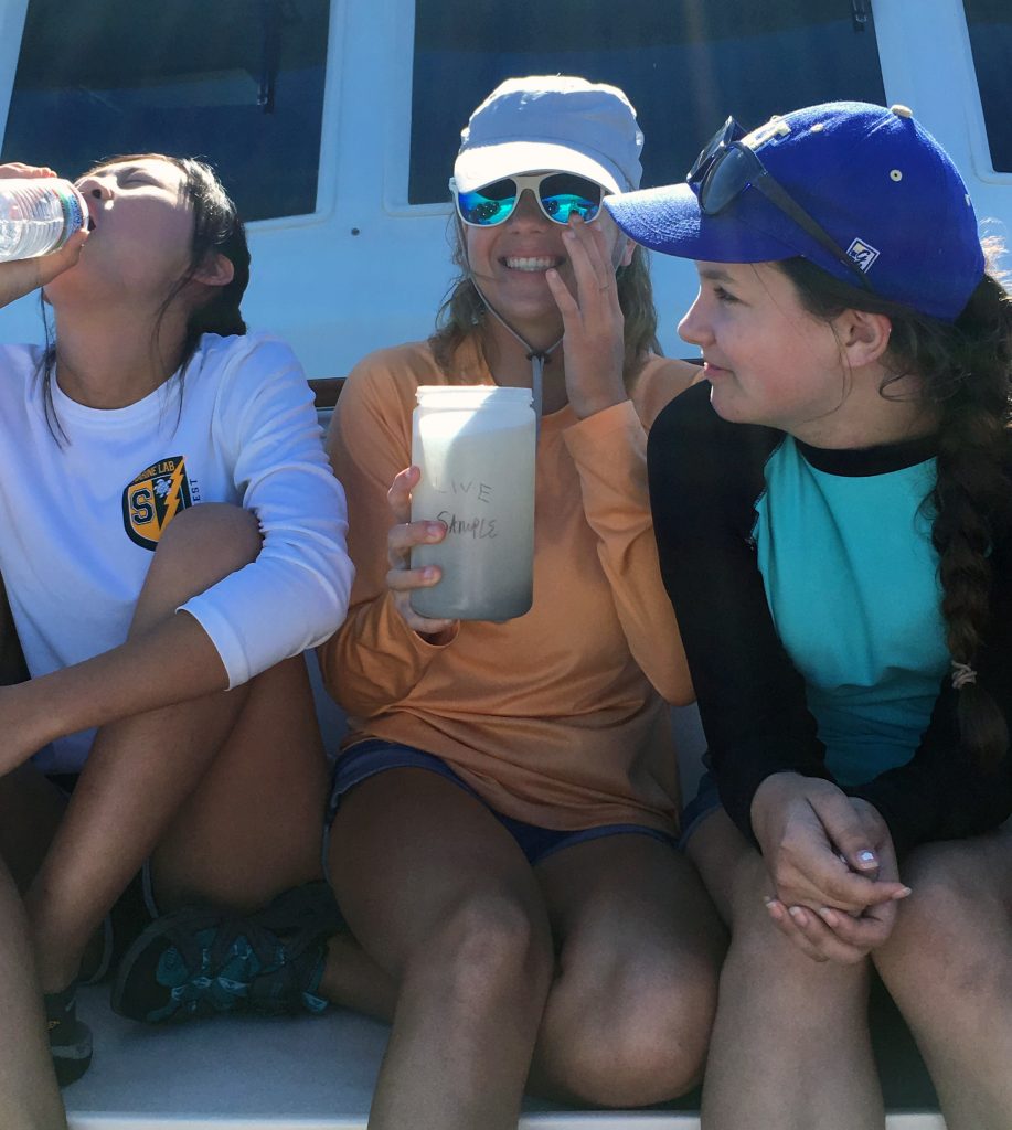 One camper readies to “chug” plankton while another washes some down with a bottle of spring water. Photo credit: OCG Staff