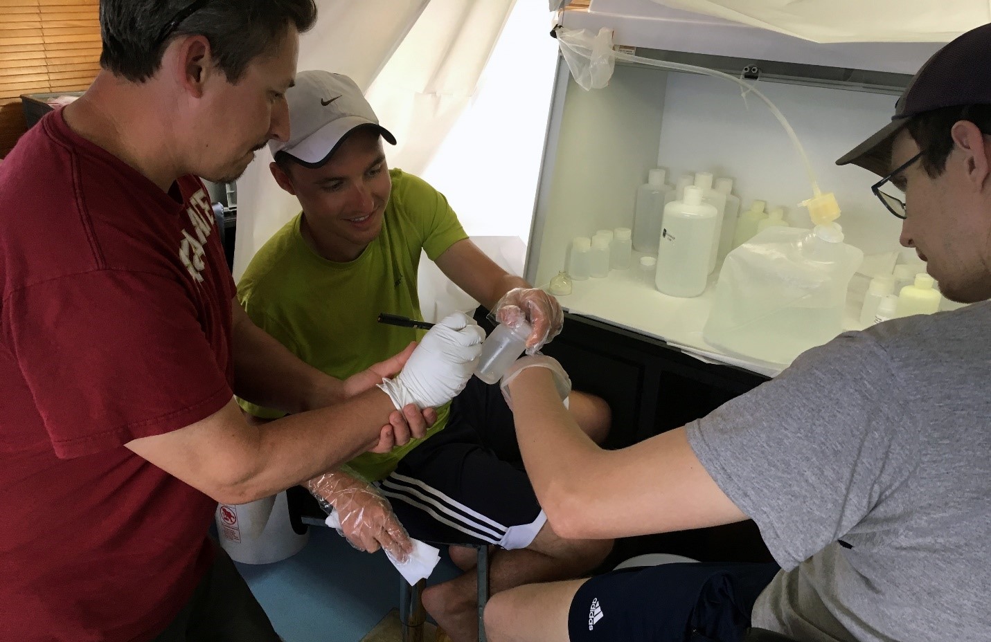 Teamwork: Dr. Peter Morton (FSU) assists Brent Summers and Travis Mellett (USFCMS) as they bag and tag another trace metals seawater sample within their “clean bubble.” Teamwork: Dr. Peter Morton (FSU) assists Brent Summers and Travis Mellett (USFCMS) as they bag and tag another trace metals seawater sample within their “clean bubble.”
