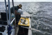 Chris Moore making adjustments to the automated, flow-through pH sampler out at the mouth of Tampa Bay.