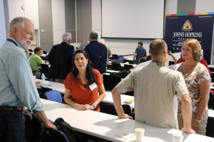 Kevin Shaw, Dr. Isabel Romero, Dr. Daniel Hahn, and Dr. Heather Judkins take advantage of a coffee break to discuss breakout sessions. Kevin Shaw, Dr. Isabel Romero, Dr. Daniel Hahn, and Dr. Heather Judkins take advantage of a coffee break to discuss breakout sessions.